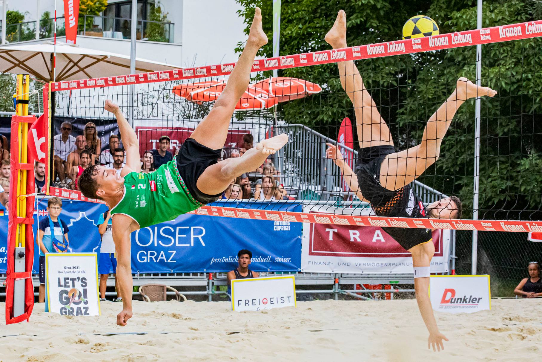 This picture shows two footvolley players doing a "shark attack".